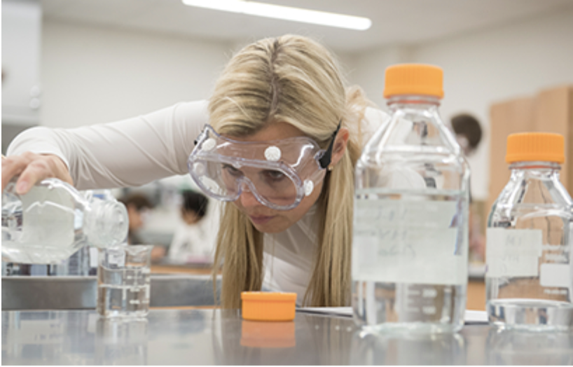 Woman in lab measuring liquids